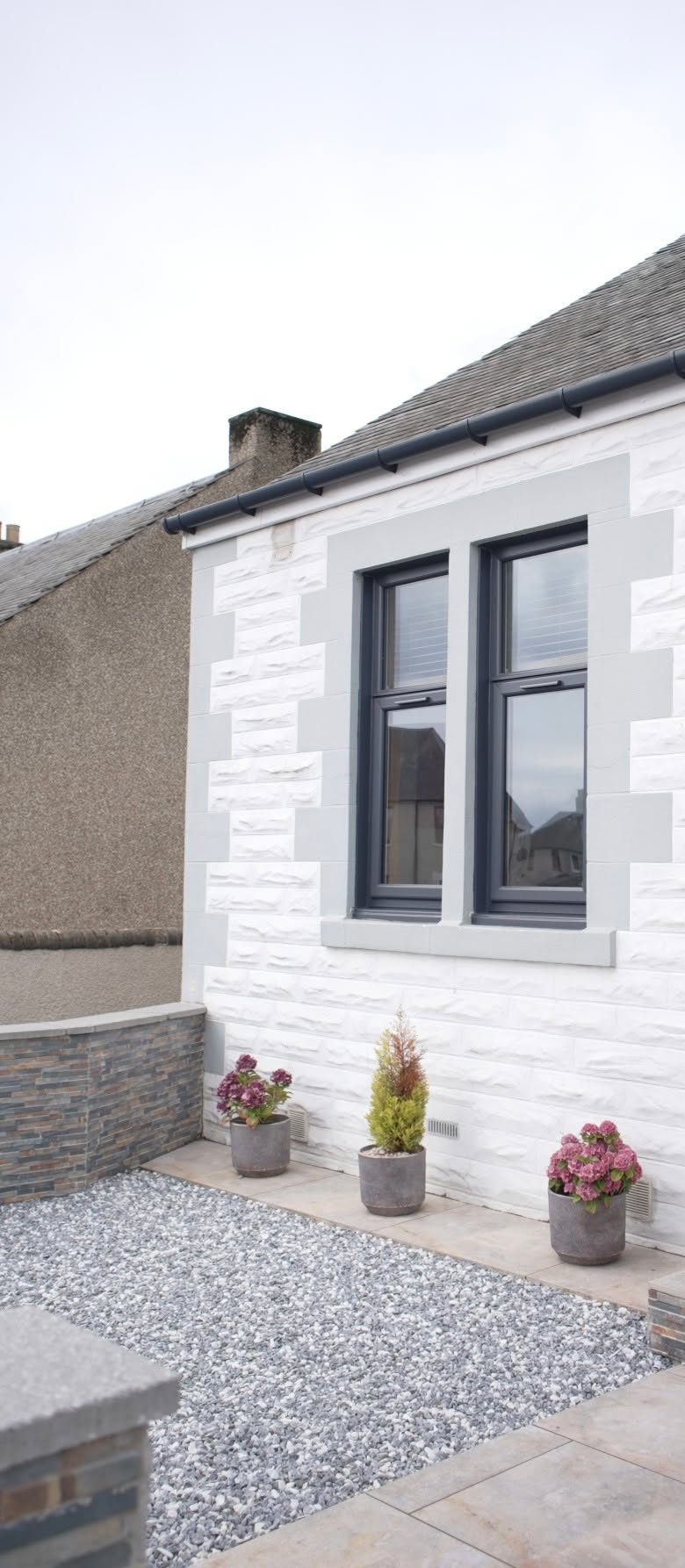 New anthracite grey windows on the white brick front of a home in Lochgelly, fitted by Eco Glaze Scotland