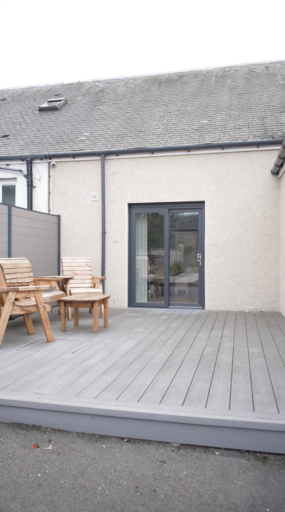 New anthracite grey sliding patio door and decking at the rear of a Lochgelly home by Eco Glaze Scotland