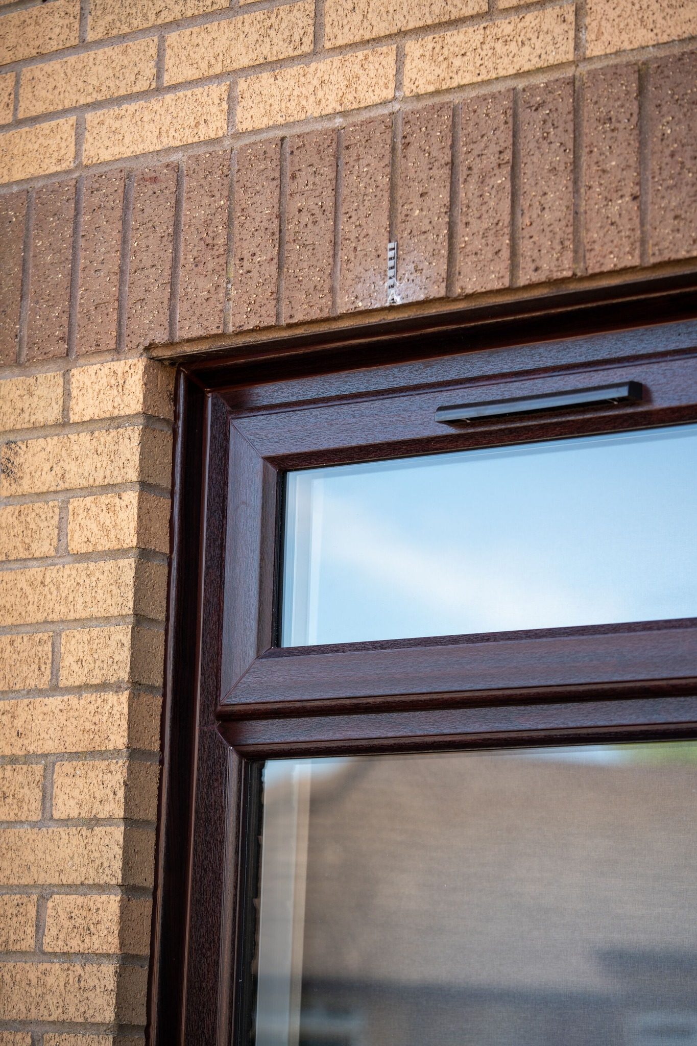 Close-up of the dark brown oak woodgrain window frame fitted in Dundee by Eco Glaze Scotland