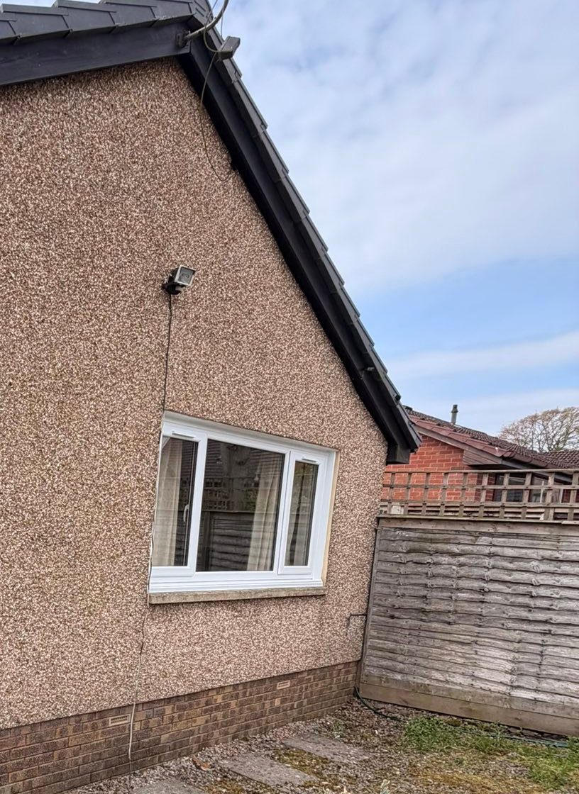 Side of the Dundee bungalow showing one of the new white replacement windows